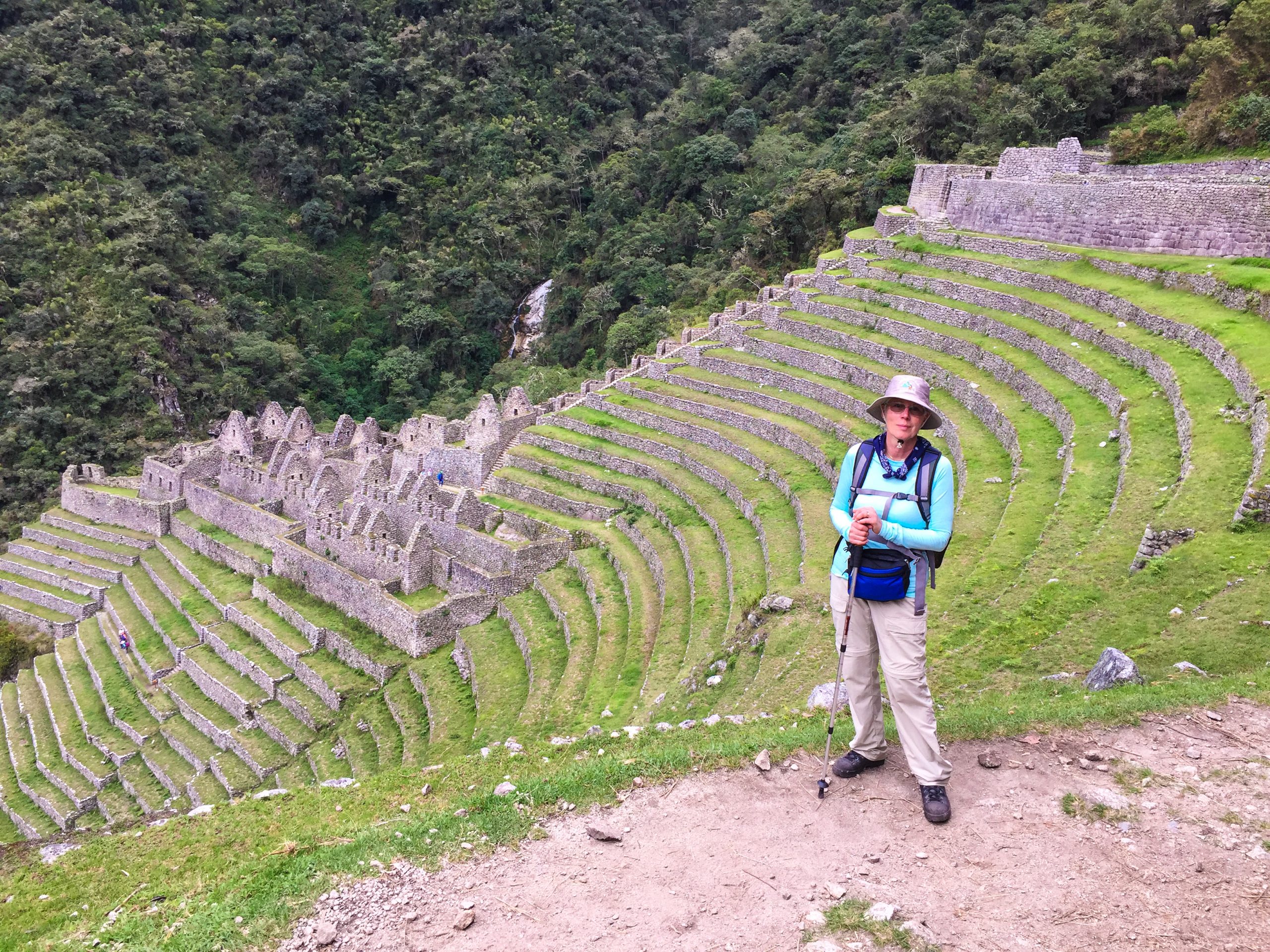 Woman standing at MAchu Picchu between two stone walls