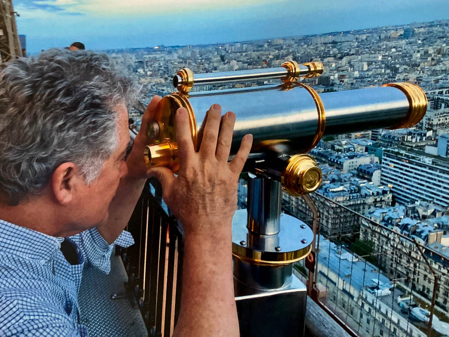 Man looking through Telescope on the Eiffel Tower in Paris